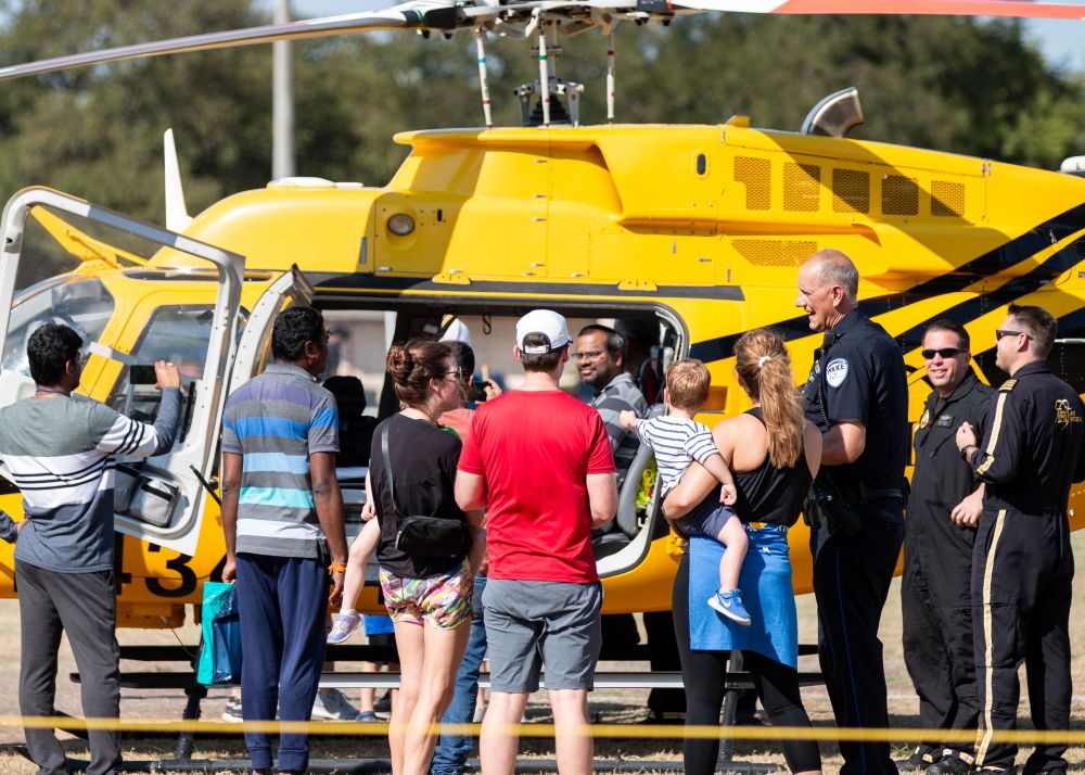 Image of families standing near first responder helicopter.